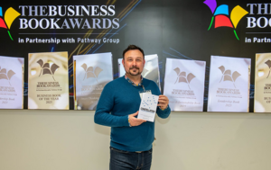 Danny Wareham holding Constellation at the Business Book Awards