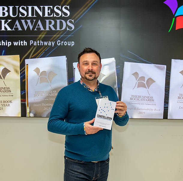 Danny Wareham holding Constellation at the Business Book Awards